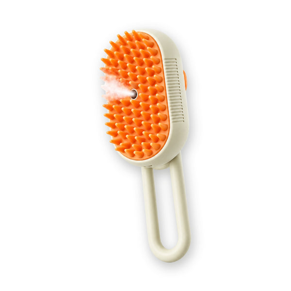 GroomHarbor Steam Cat Brush, cream handheld spray-mist pet brush with soft orange silicone pins and a long loop handle